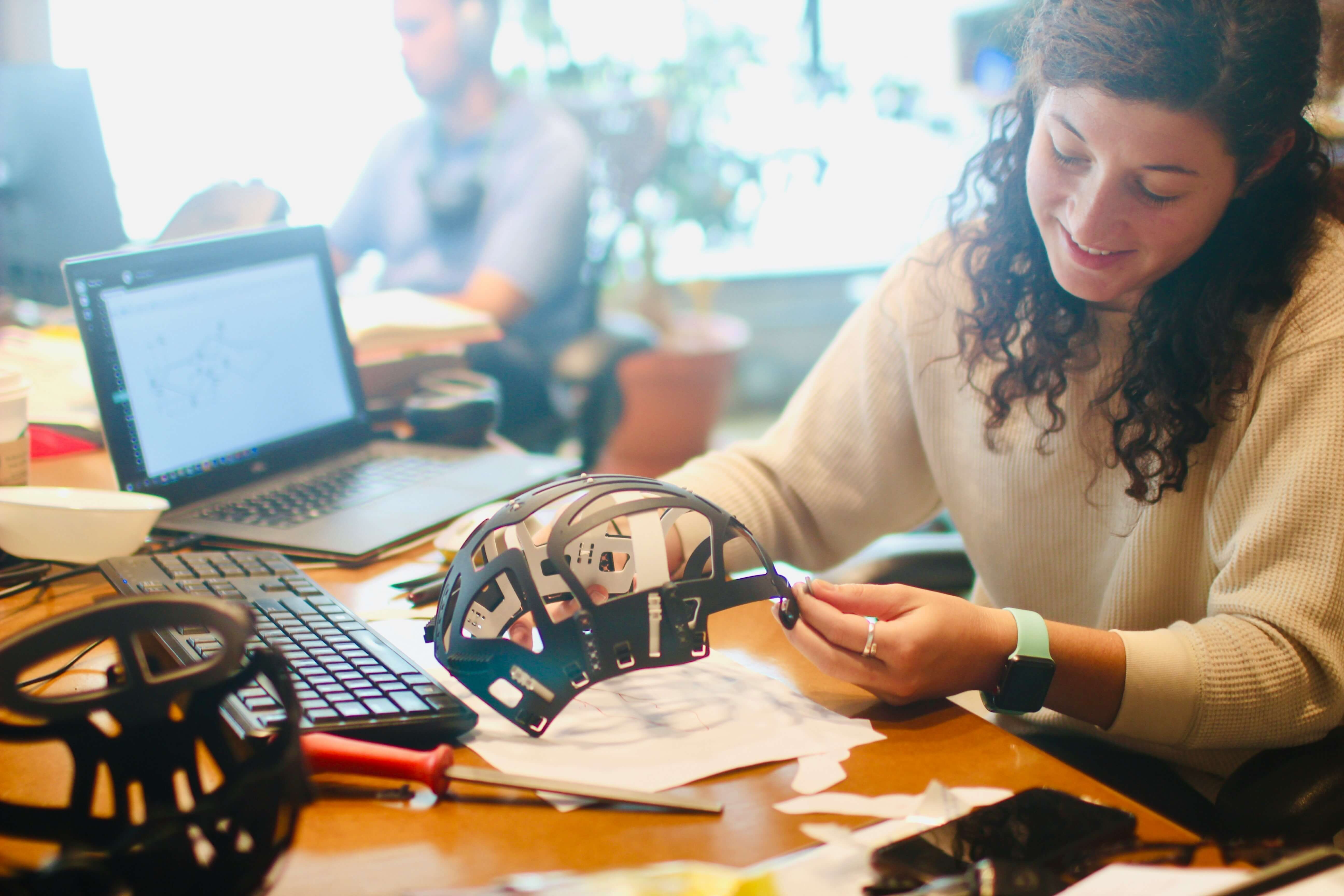 A woman working on a product casing.