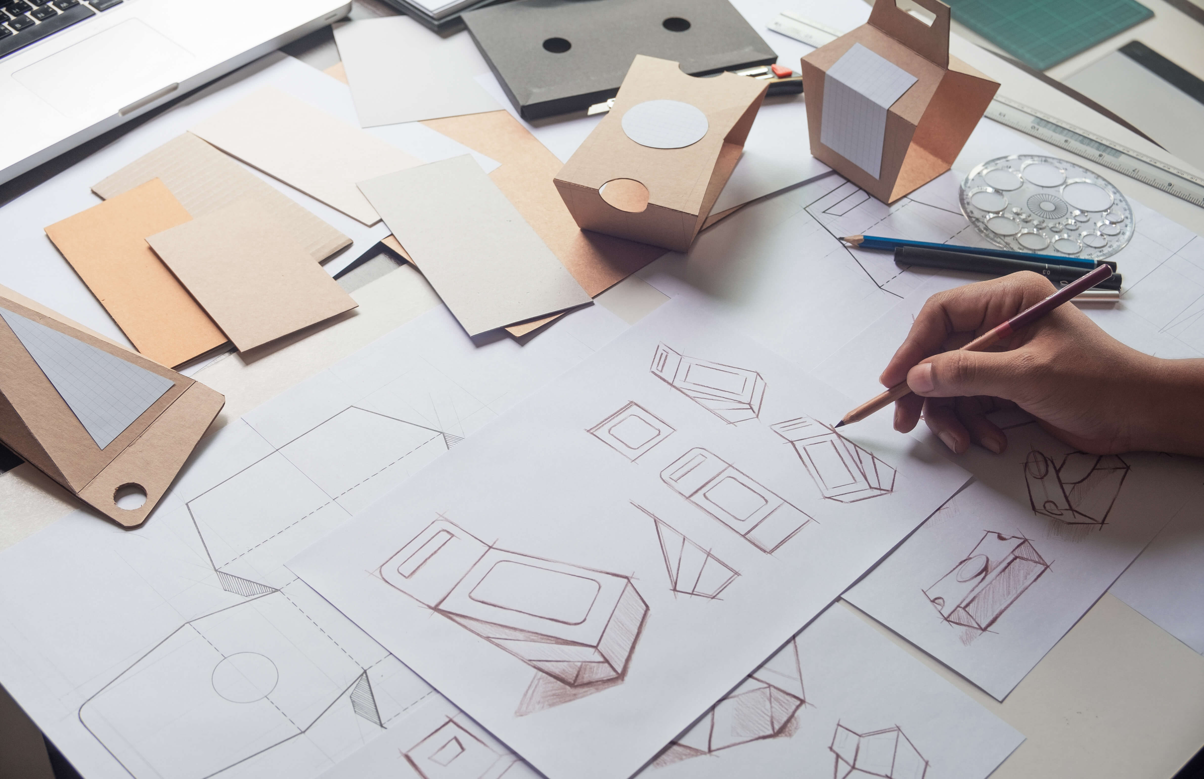 A designer drawing mock-ups of a product.