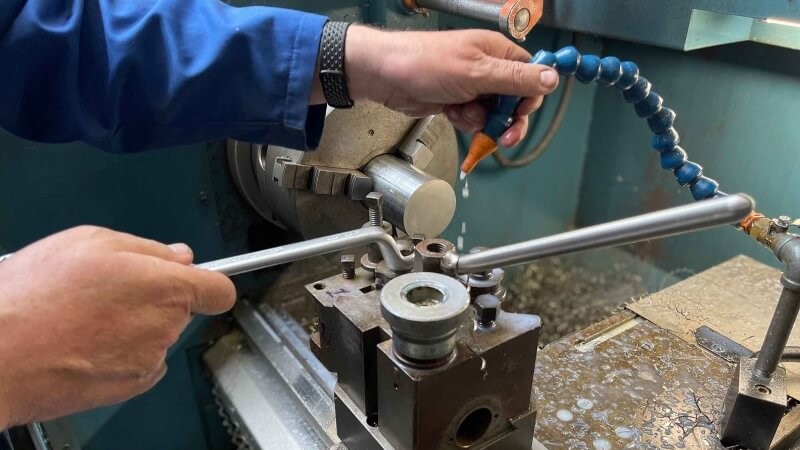 A man using a machine which is used within GBE's local manufacturing process